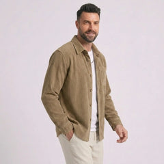 Man wearing MannerCo khaki corduroy long sleeve shirt, side view on plain background