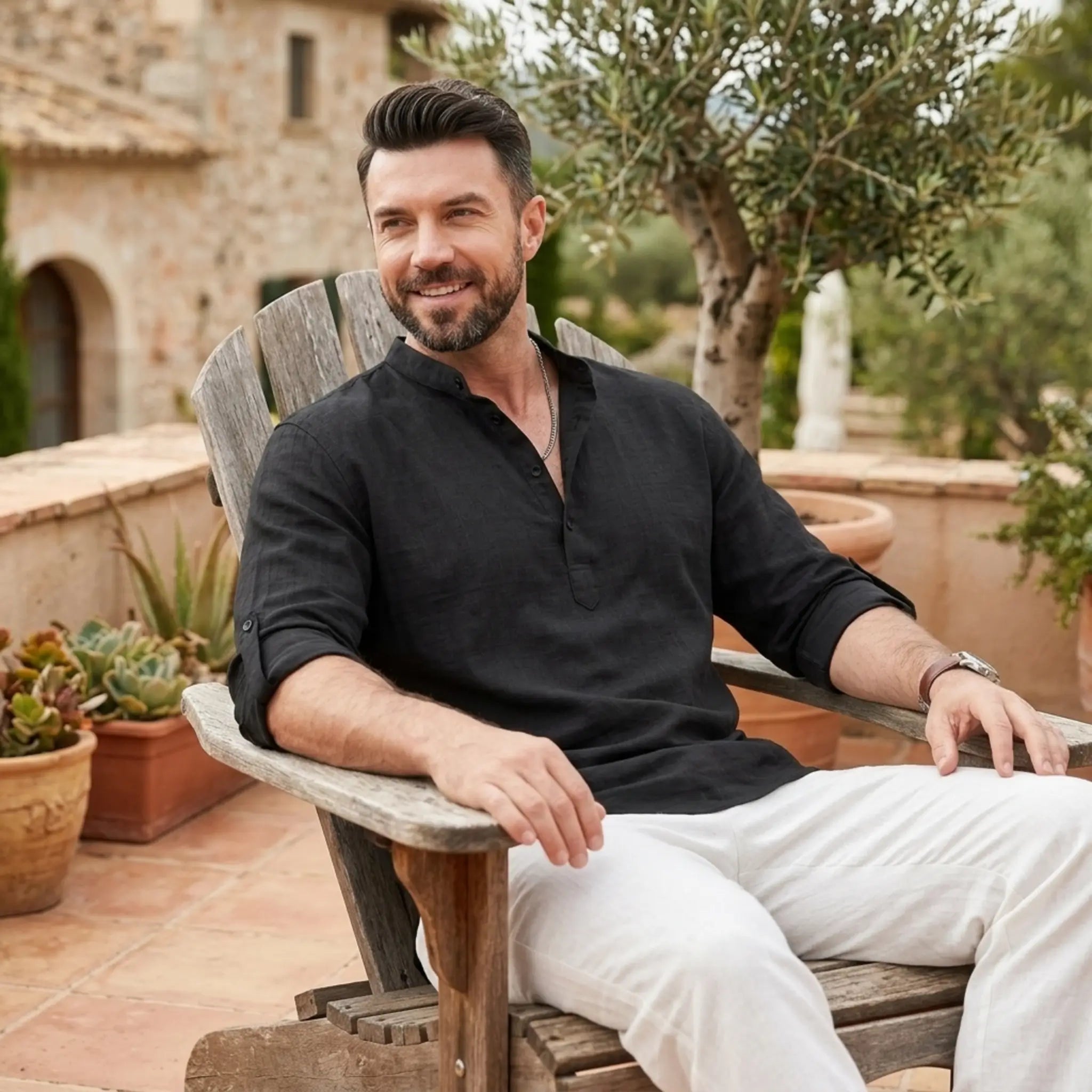 Man wearing MannerCo black cotton linen Henley shirt in outdoor lifestyle setting