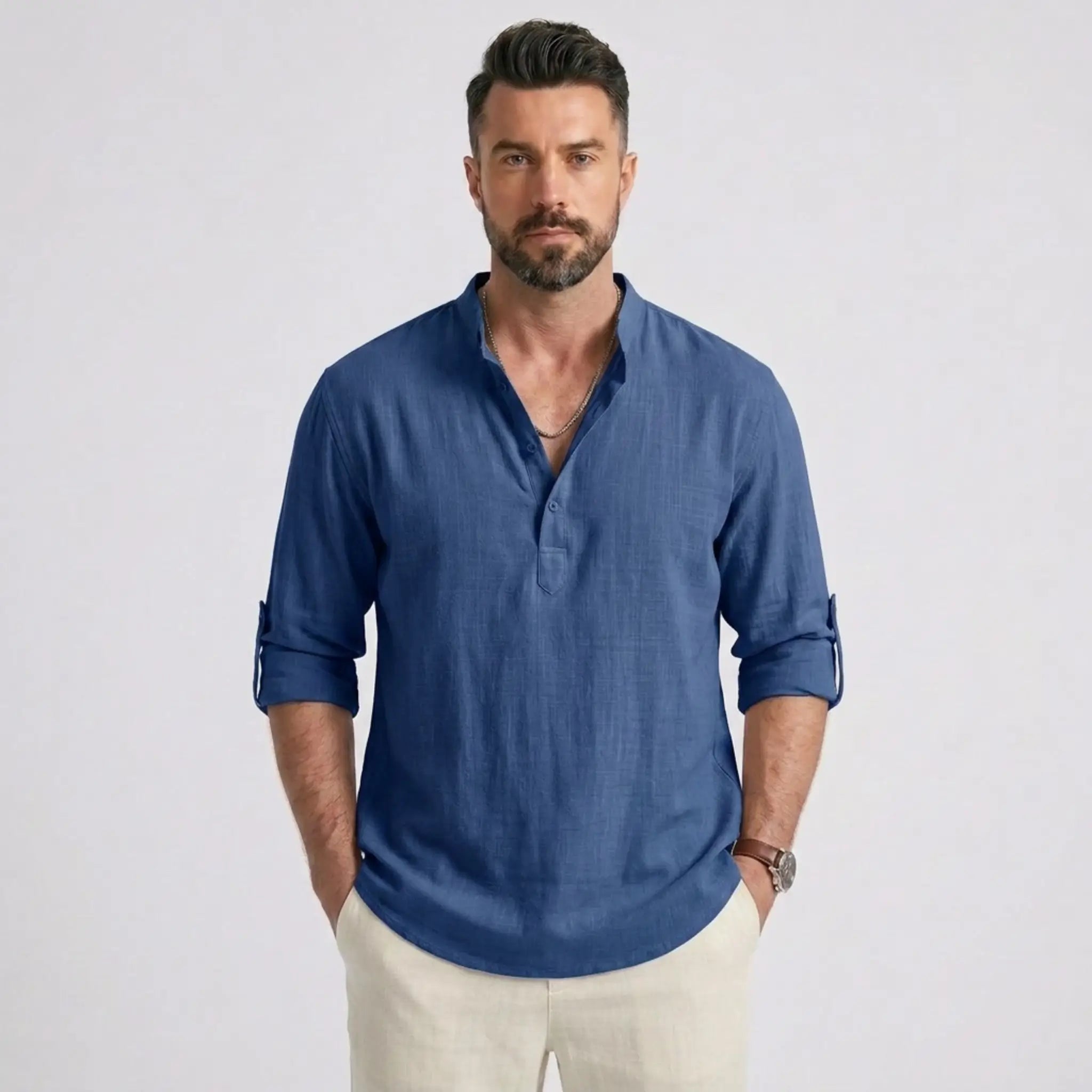 Man wearing MannerCo denim blue cotton linen long sleeve Henley shirt with stand collar, front view