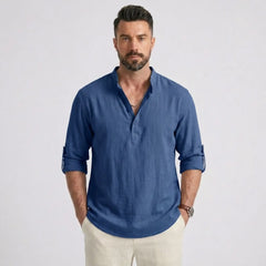 Man wearing MannerCo denim blue cotton linen long sleeve Henley shirt with stand collar, front view