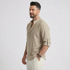 Man wearing MannerCo khaki cotton linen long sleeve Henley shirt, back view on plain background