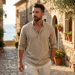 Man wearing MannerCo pink cotton linen long sleeve Henley shirt, side view on plain background