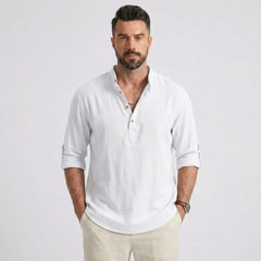 Man wearing MannerCo white cotton linen Henley shirt in outdoor lifestyle setting
