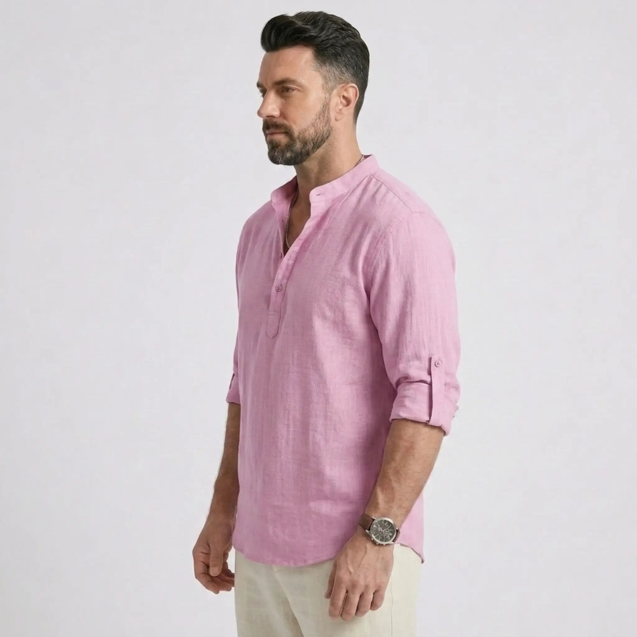 Man wearing MannerCo white cotton linen long sleeve Henley shirt, side view on plain background