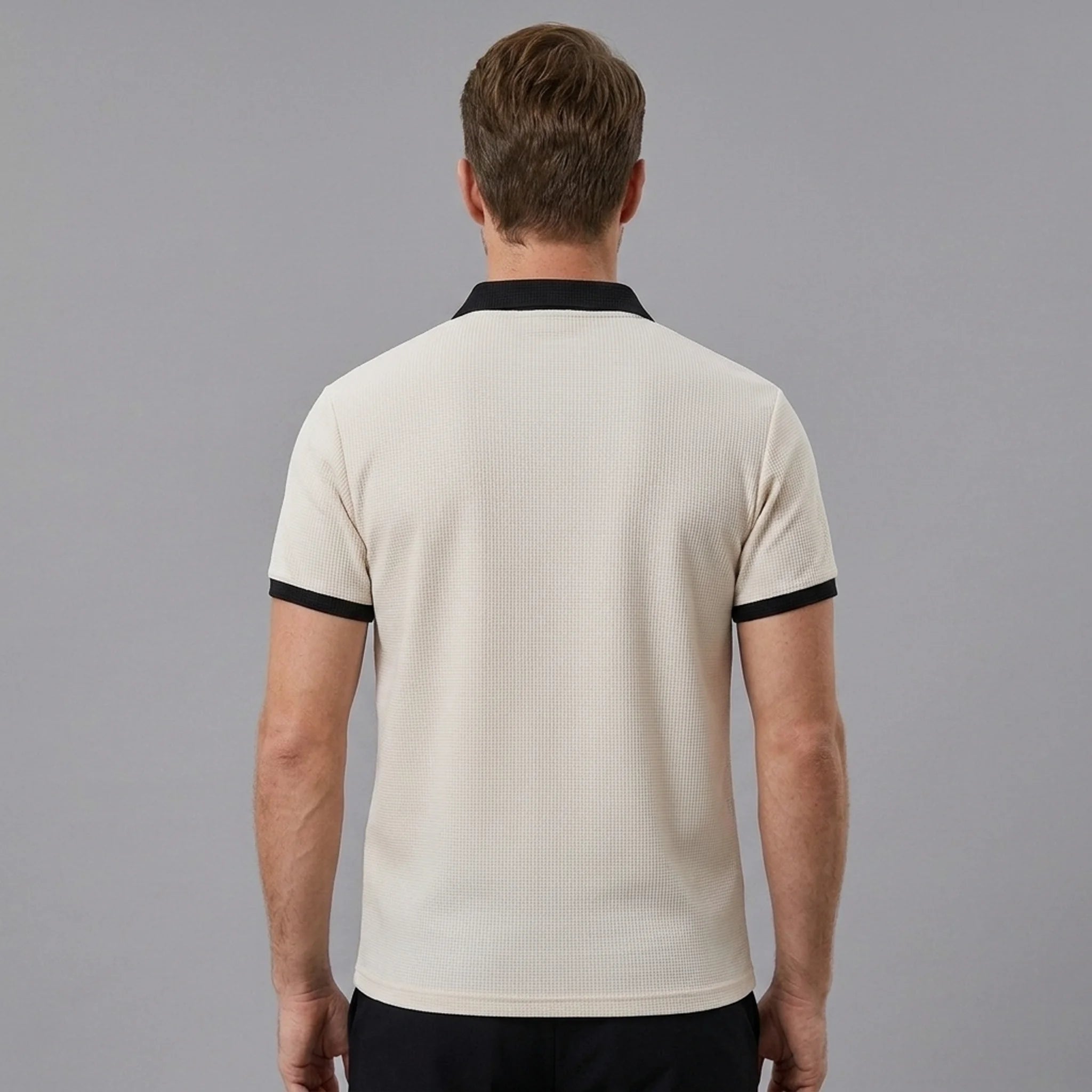 Back view of man wearing dark green color block waffle polo shirt