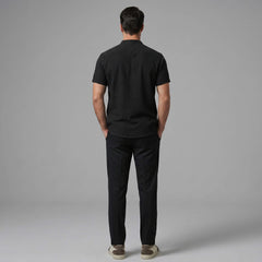 Back view of man wearing dark green linen look stand collar shirt and slim fit tapered trousers