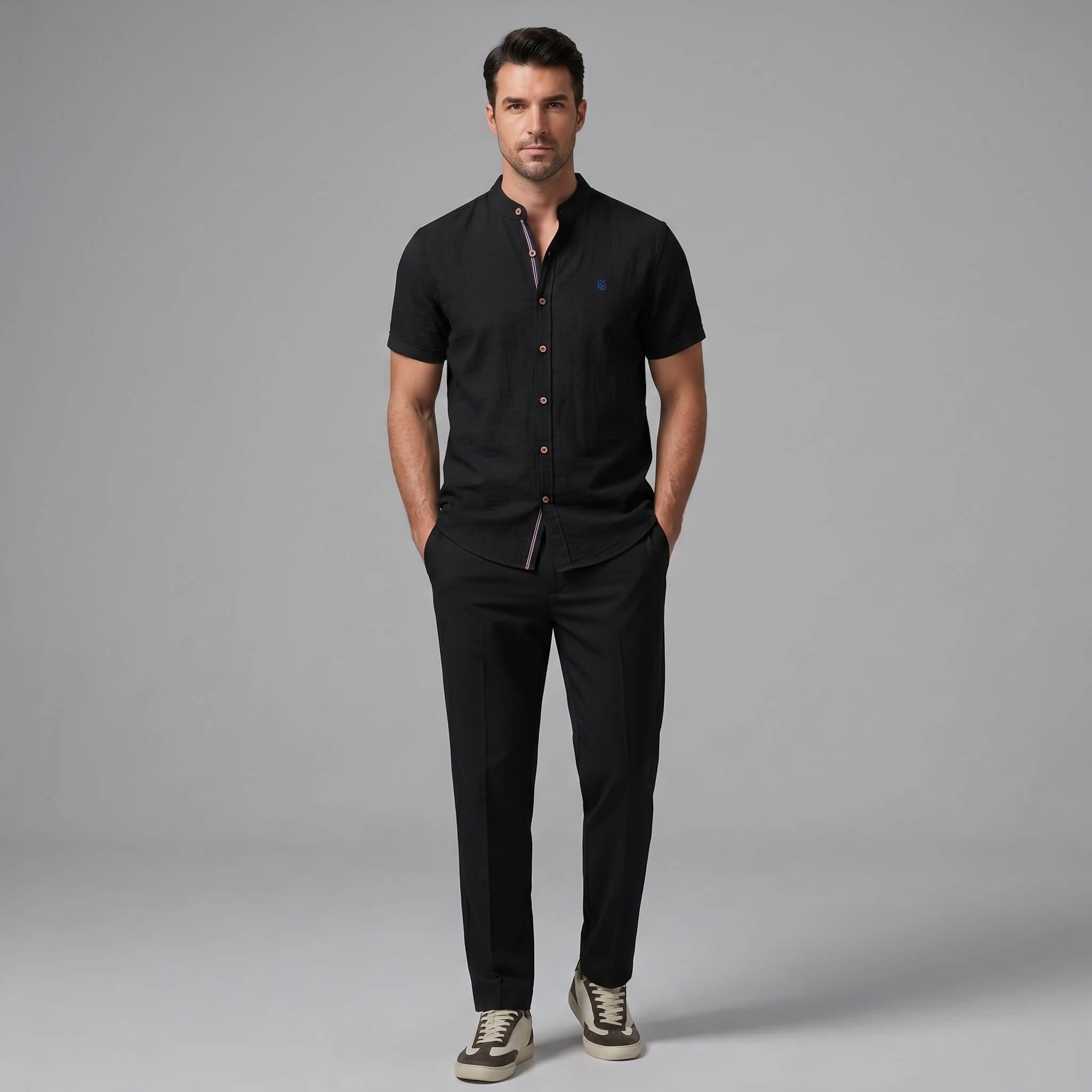 Man wearing a dark green linen look stand collar shirt and slim fit tapered trousers front view
