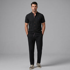 Man wearing a dark green linen look stand collar shirt and slim fit tapered trousers front view