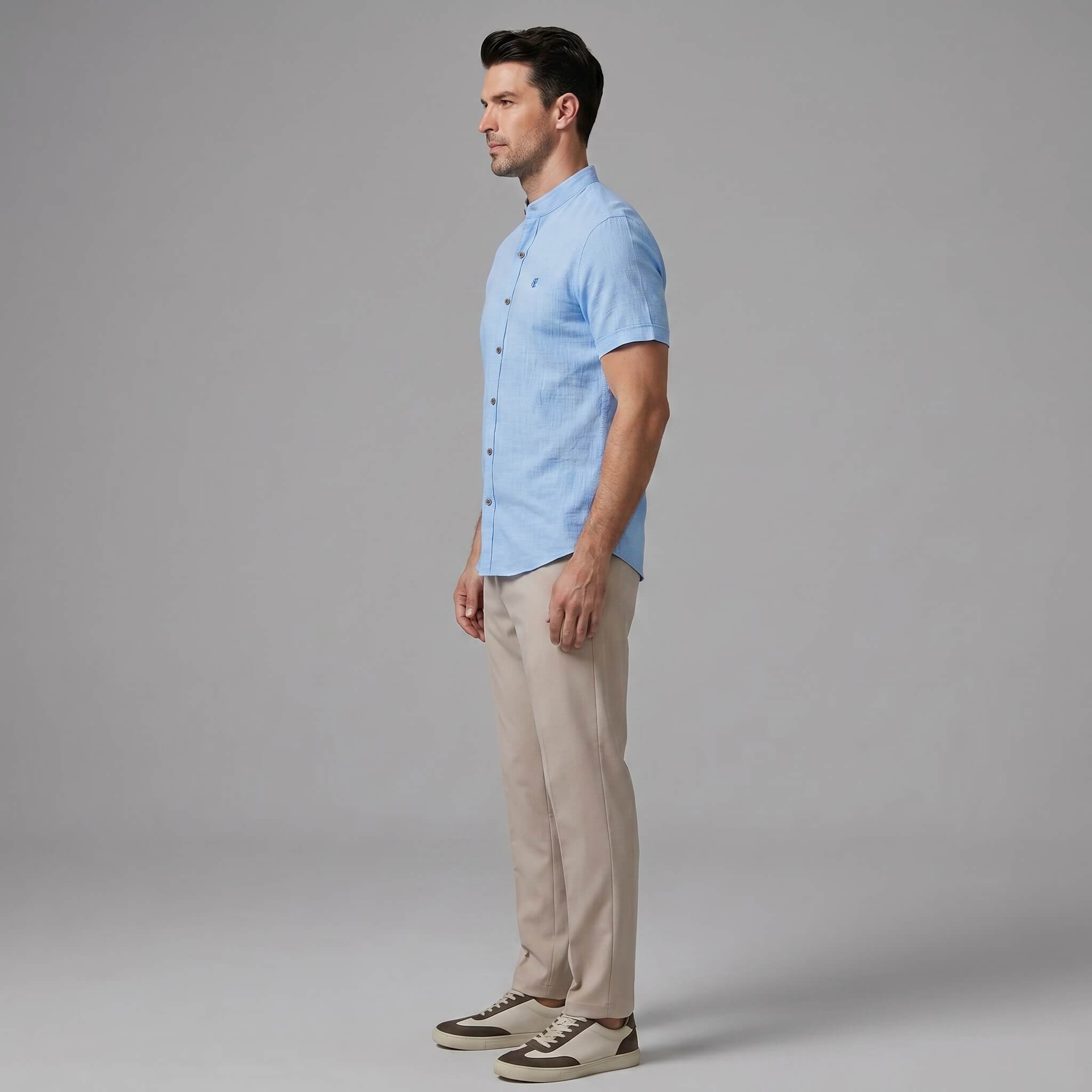 Full length view of man in dark green linen look stand collar shirt and slim tapered trousers