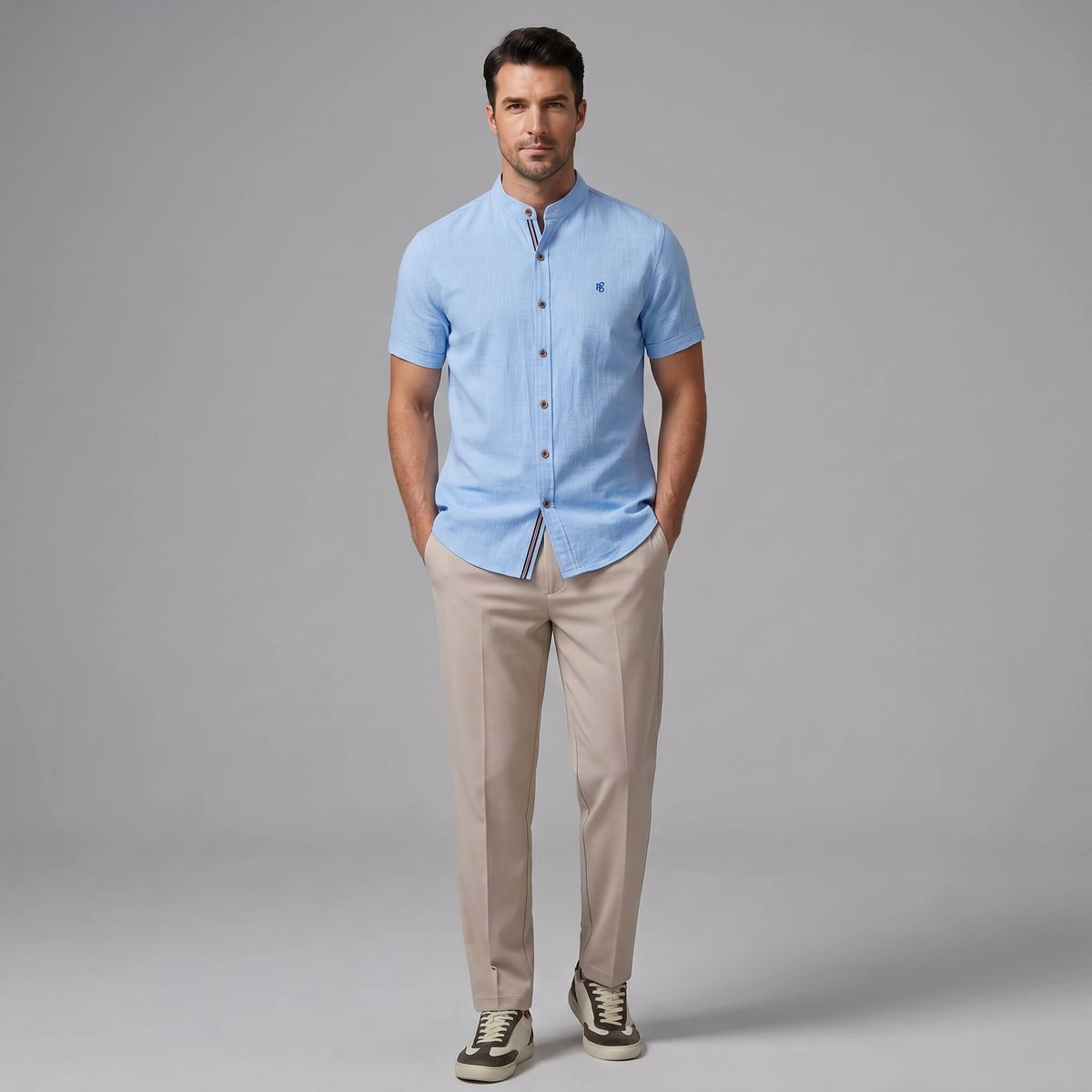 Man wearing a dark green linen look stand collar shirt and tapered trousers walking in outdoor lifestyle