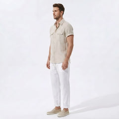 Side view of man in dark green linen rayon blend utility shirt and straight leg linen pants