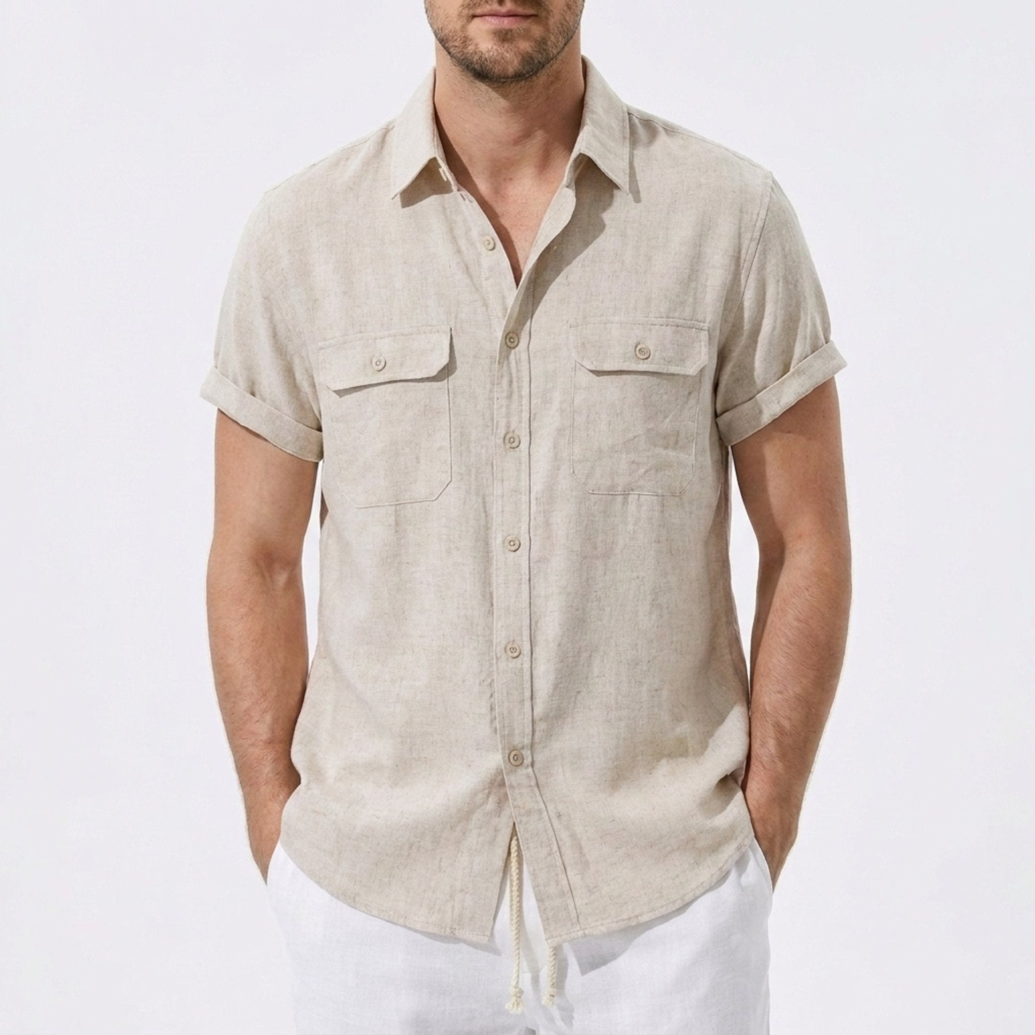Three quarter view of man in dark green linen rayon blend utility shirt and linen pants