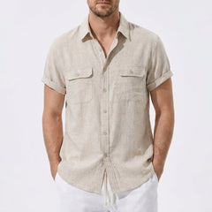 Three quarter view of man in dark green linen rayon blend utility shirt and linen pants