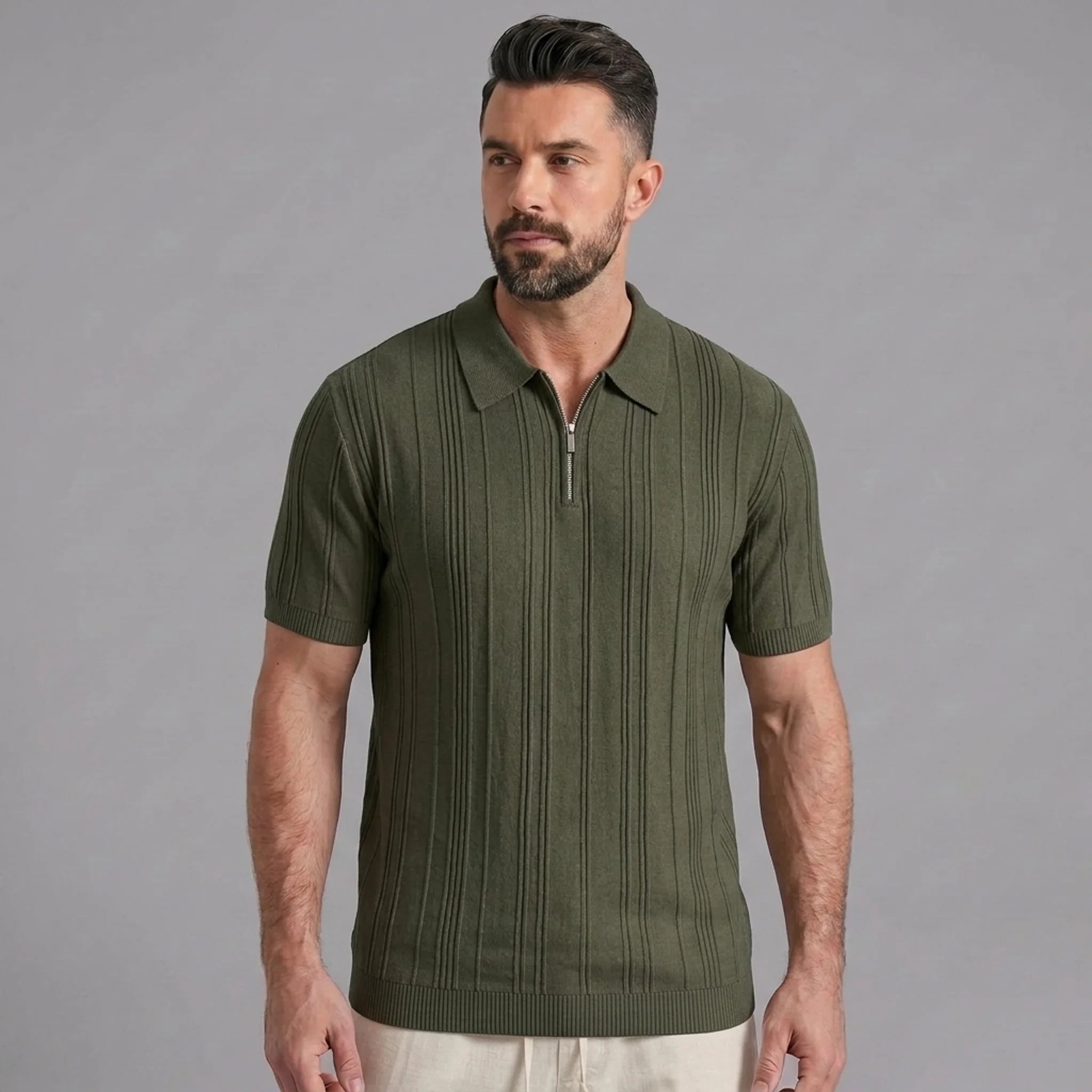 Man wearing a dark green stripe jacquard knit zip-up polo shirt front view on plain background