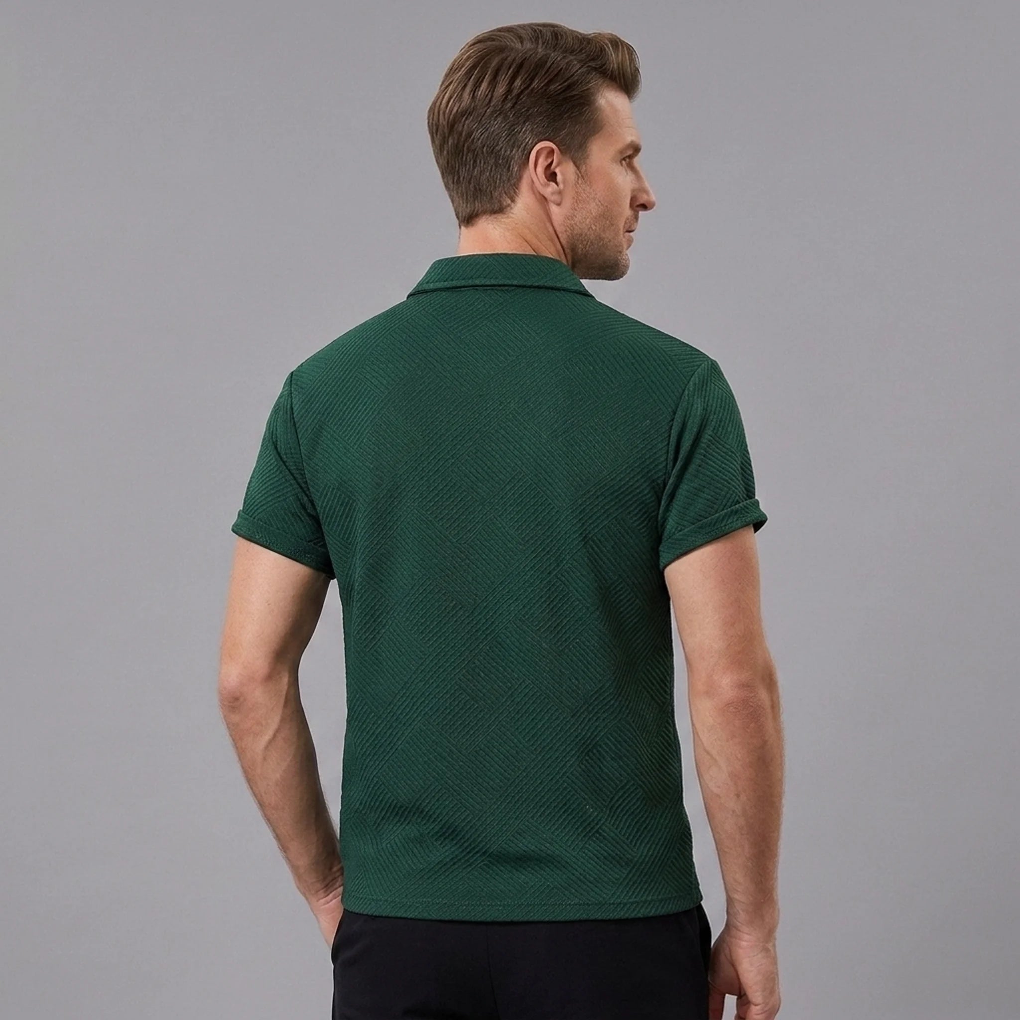 Back view of man wearing dark green stripe jacquard zip-up polo shirt