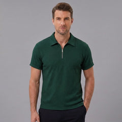 Man wearing a dark green stripe jacquard zip-up polo shirt front view on plain background