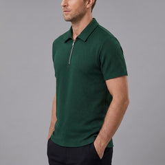 Man wearing dark green stripe jacquard zip-up polo shirt in outdoor lifestyle setting