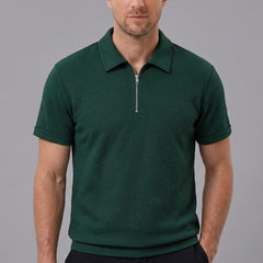 Side view of man in dark green stripe jacquard zip-up polo shirt on plain background
