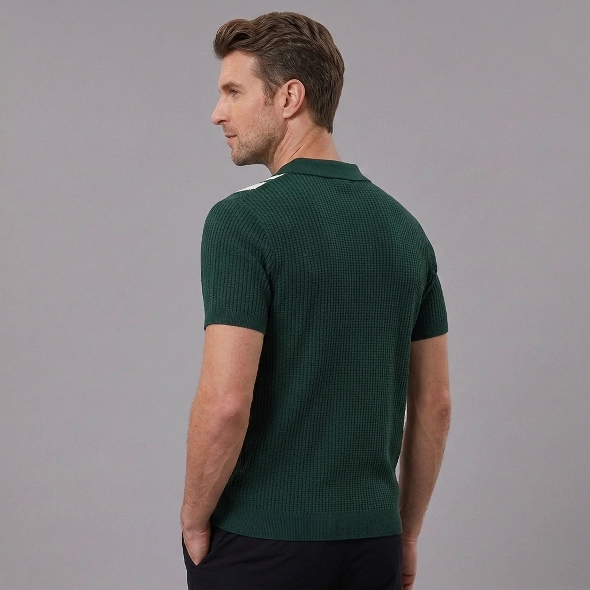 Back view of man wearing dark green striped knit slim fit polo shirt