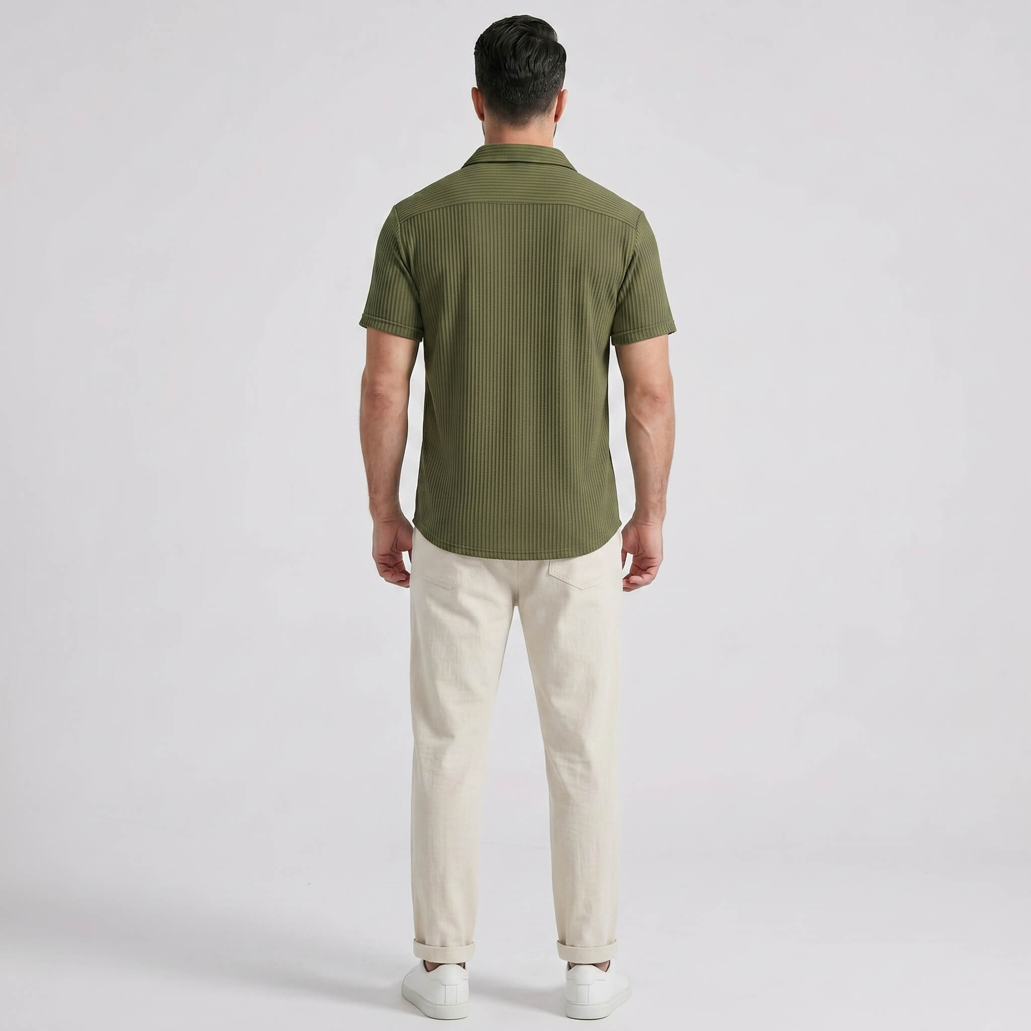 Back view of man wearing dark green waffle button up shirt and straight leg linen pants