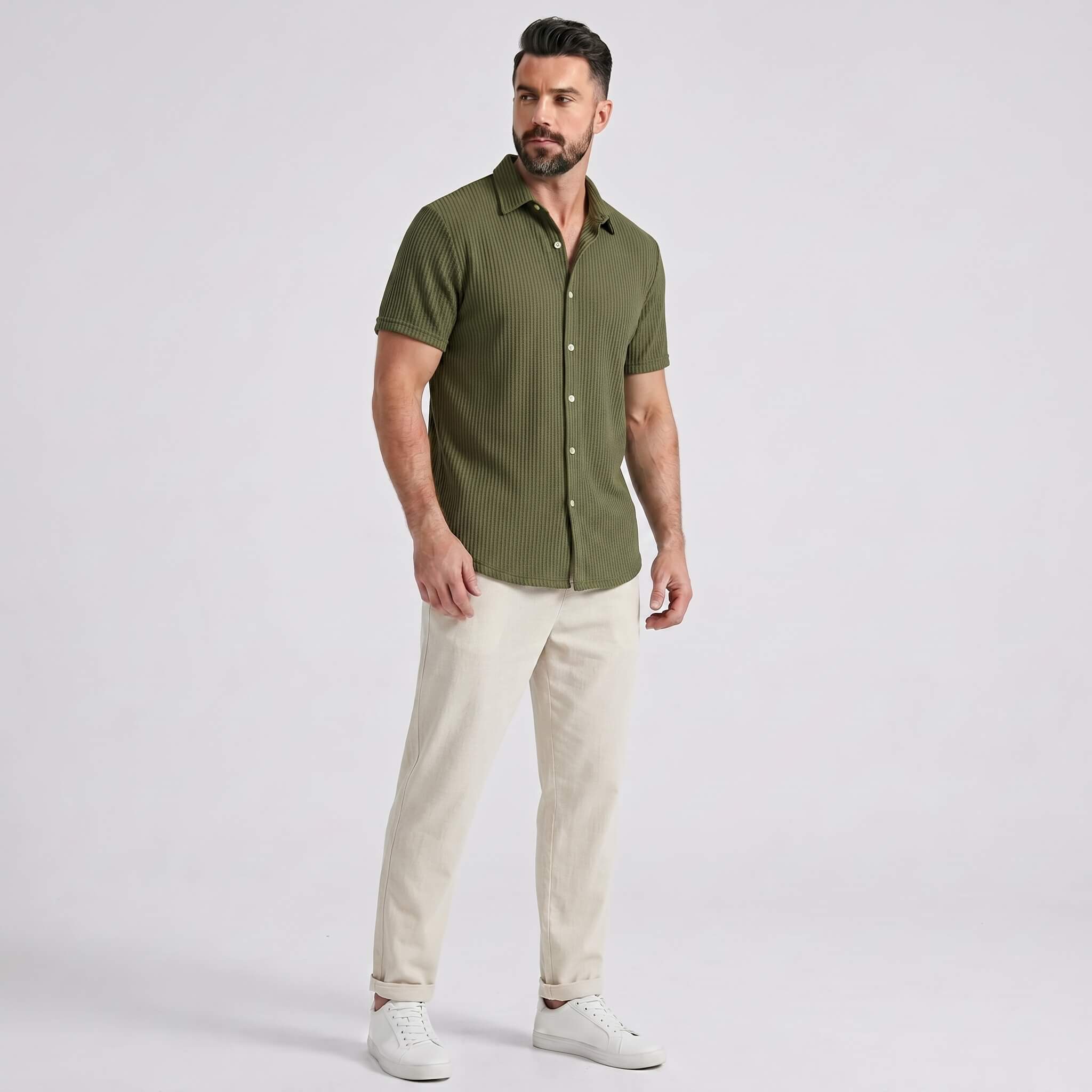 Man wearing a dark green waffle button up shirt and straight leg linen pants front view on plain background