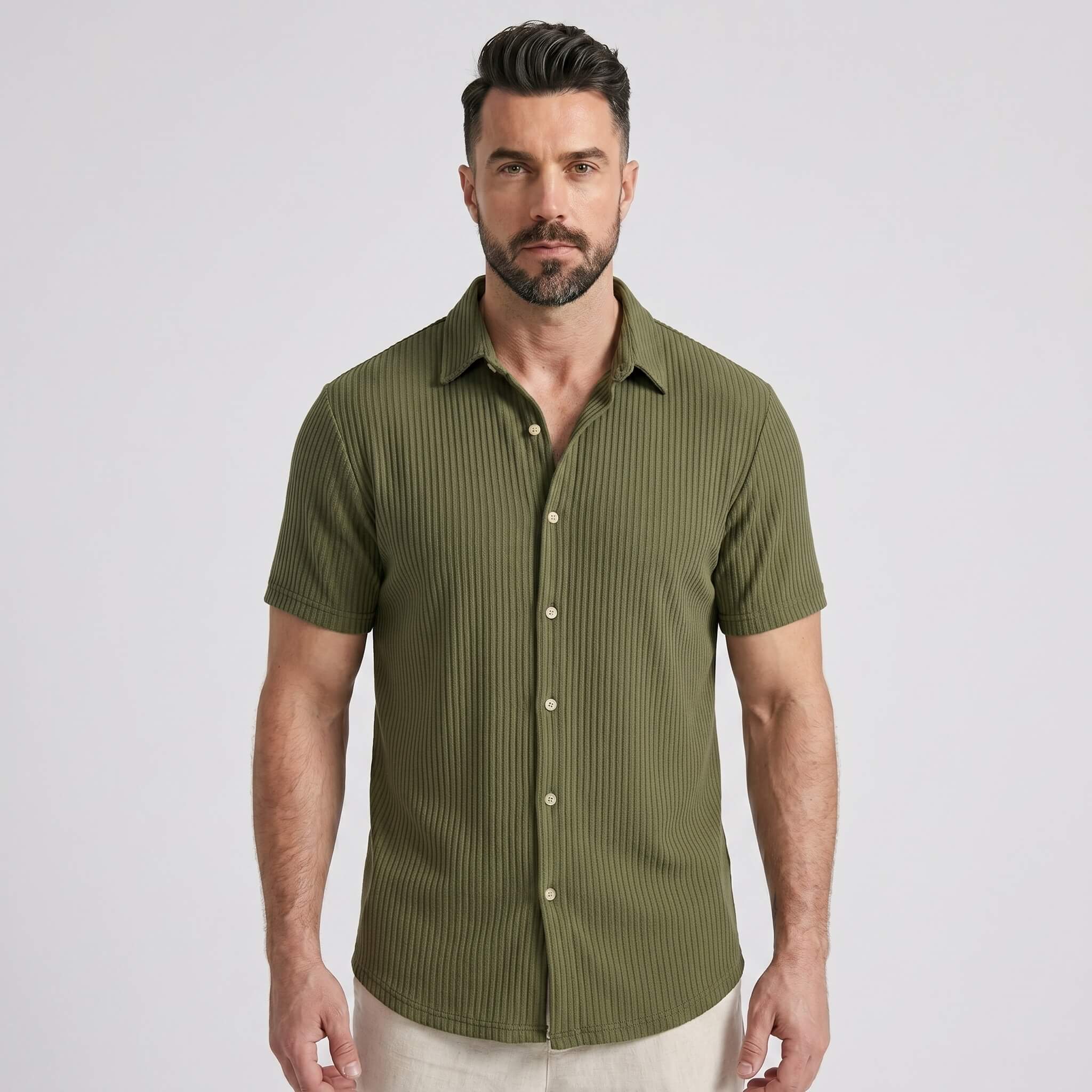 Three quarter view of man in dark green waffle button up shirt and straight leg linen pants