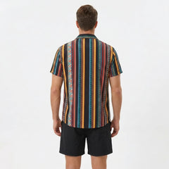 Back view of man wearing colorful ethnic geometric print shirt and swim shorts