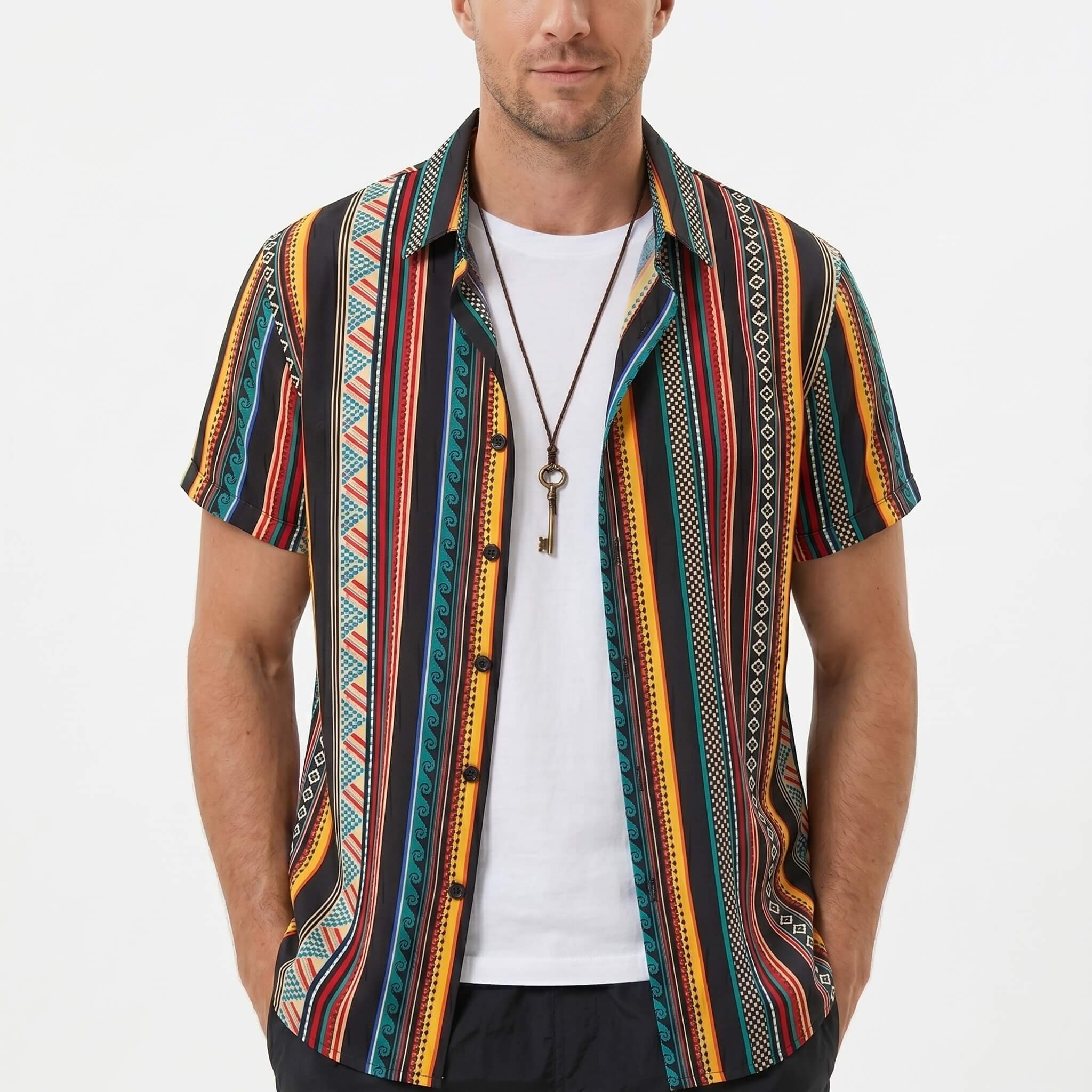 Three quarter view of man in ethnic geometric print shirt and swim shorts on plain background