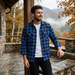 MannerCo blue plaid flannel shirt with turn-down collar worn open over white tee in mountain setting