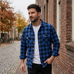 MannerCo blue plaid flannel shirt with turn-down collar worn open over white tee on cobblestone street