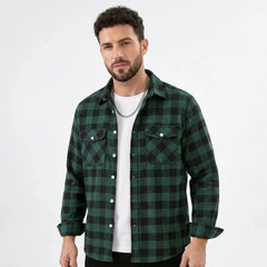 MannerCo green plaid flannel shirt with turn-down collar and chest pockets worn open over white tee