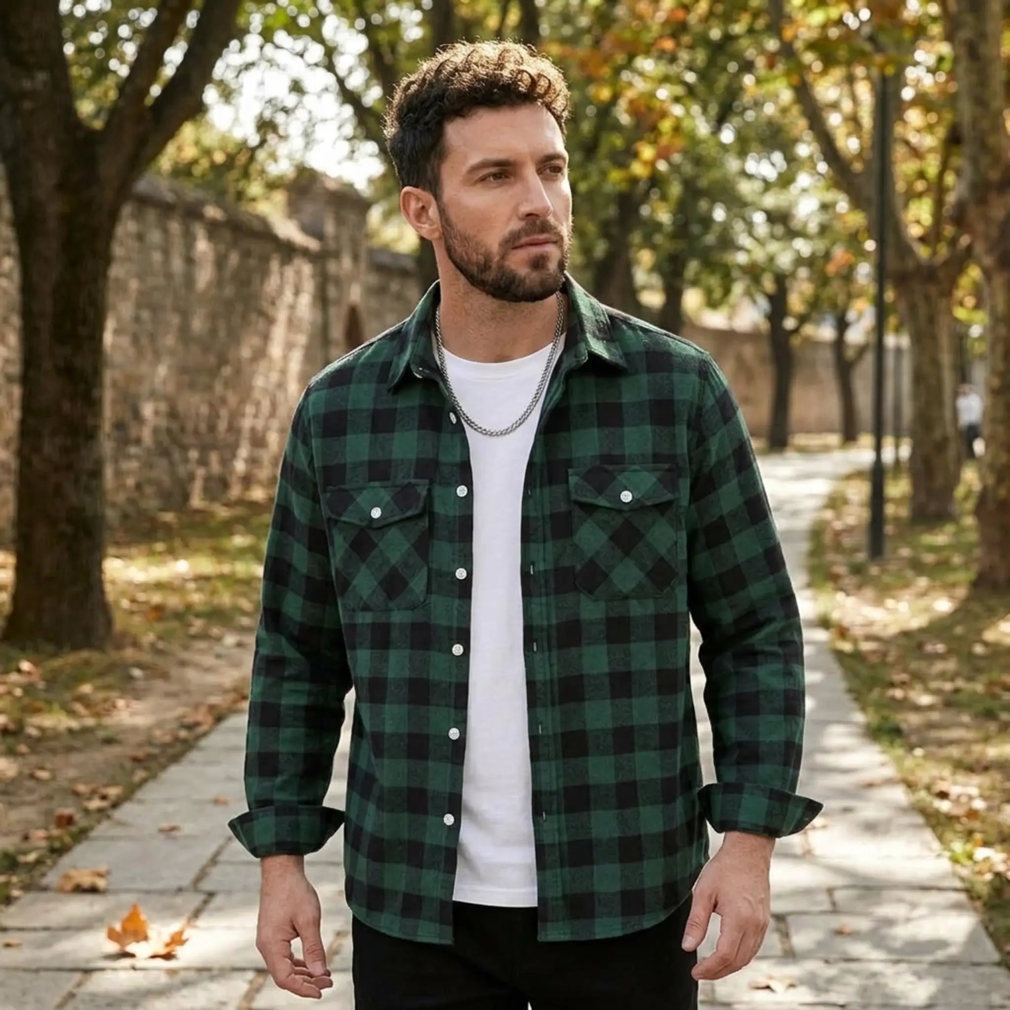 MannerCo green plaid flannel shirt with turn-down collar worn open over white tee outdoors