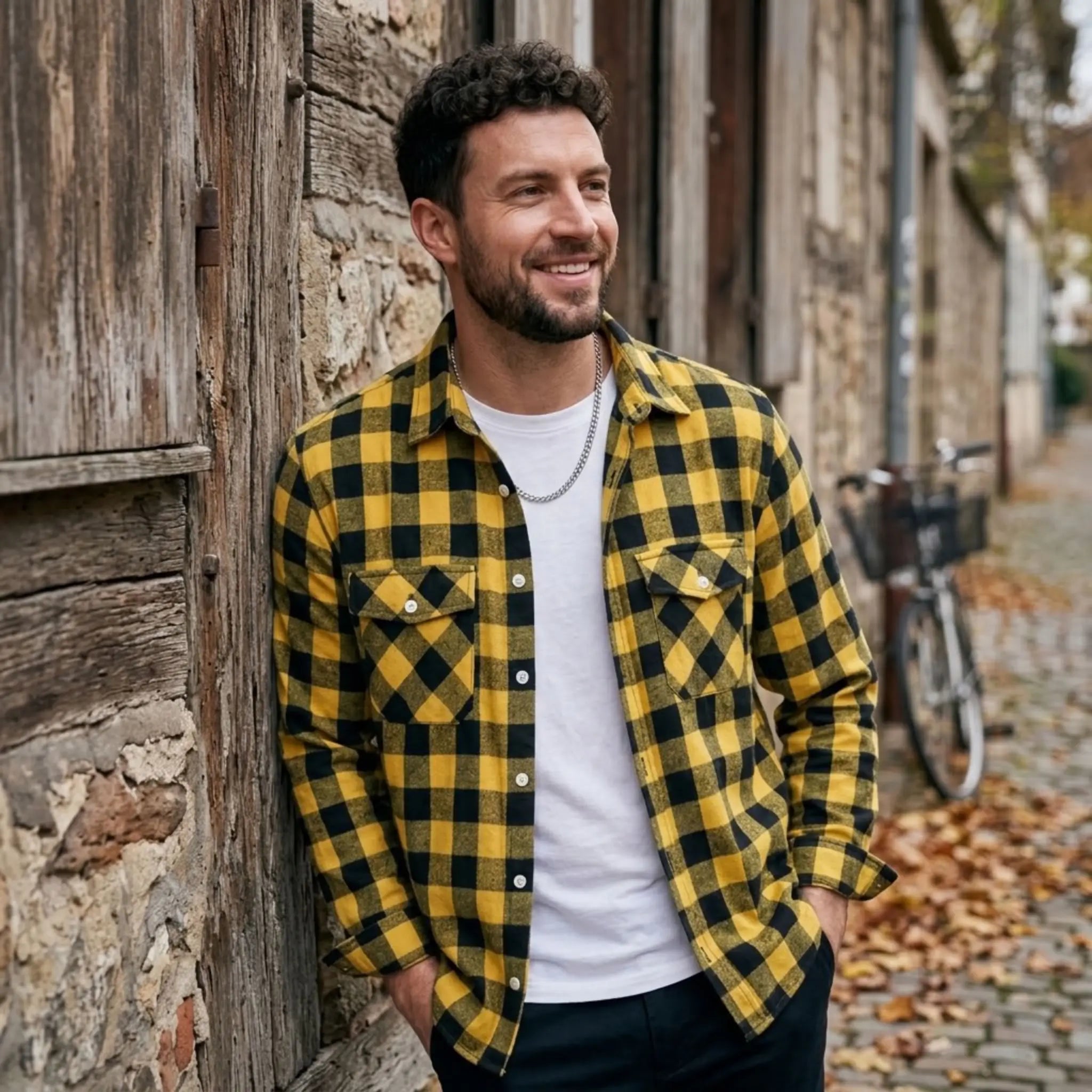 MannerCo yellow plaid flannel shirt with turn-down collar worn open over white tee outdoors