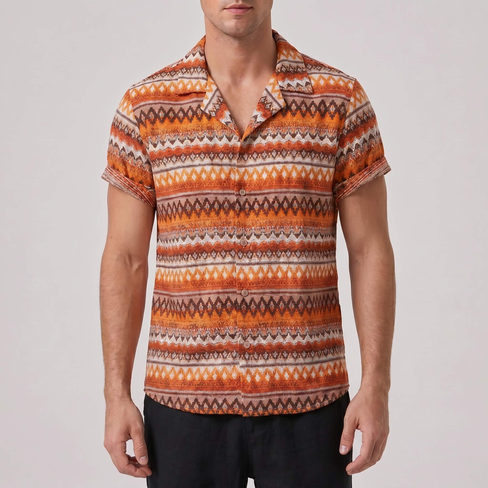 Man wearing a patterned orange and brown shirt against a plain background