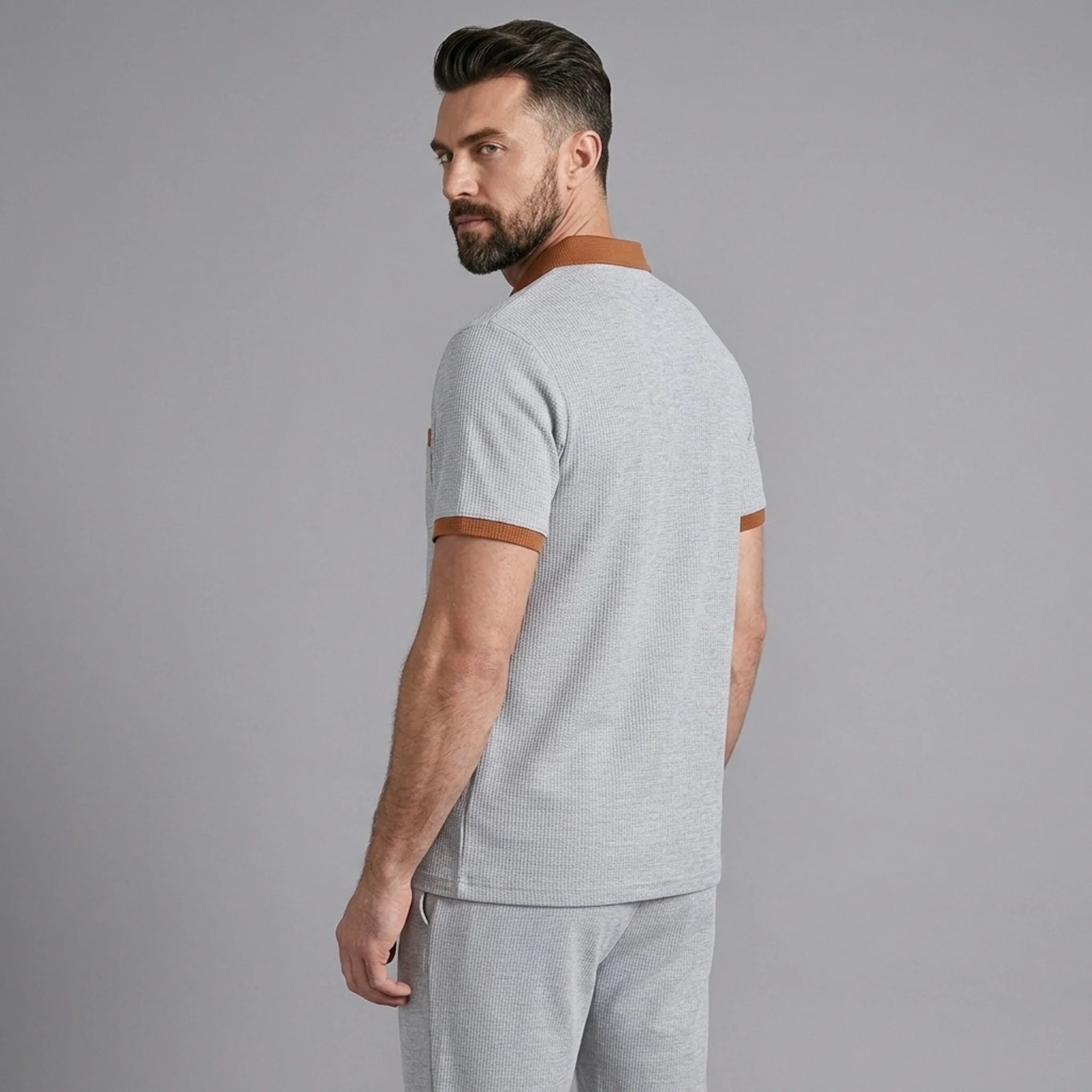 Back view of man wearing gray color block waffle polo and straight leg pants