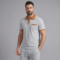 Man wearing a gray color block waffle polo shirt and straight leg pants front view