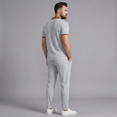 Man wearing gray color block waffle polo and straight leg pants outdoor lifestyle setting