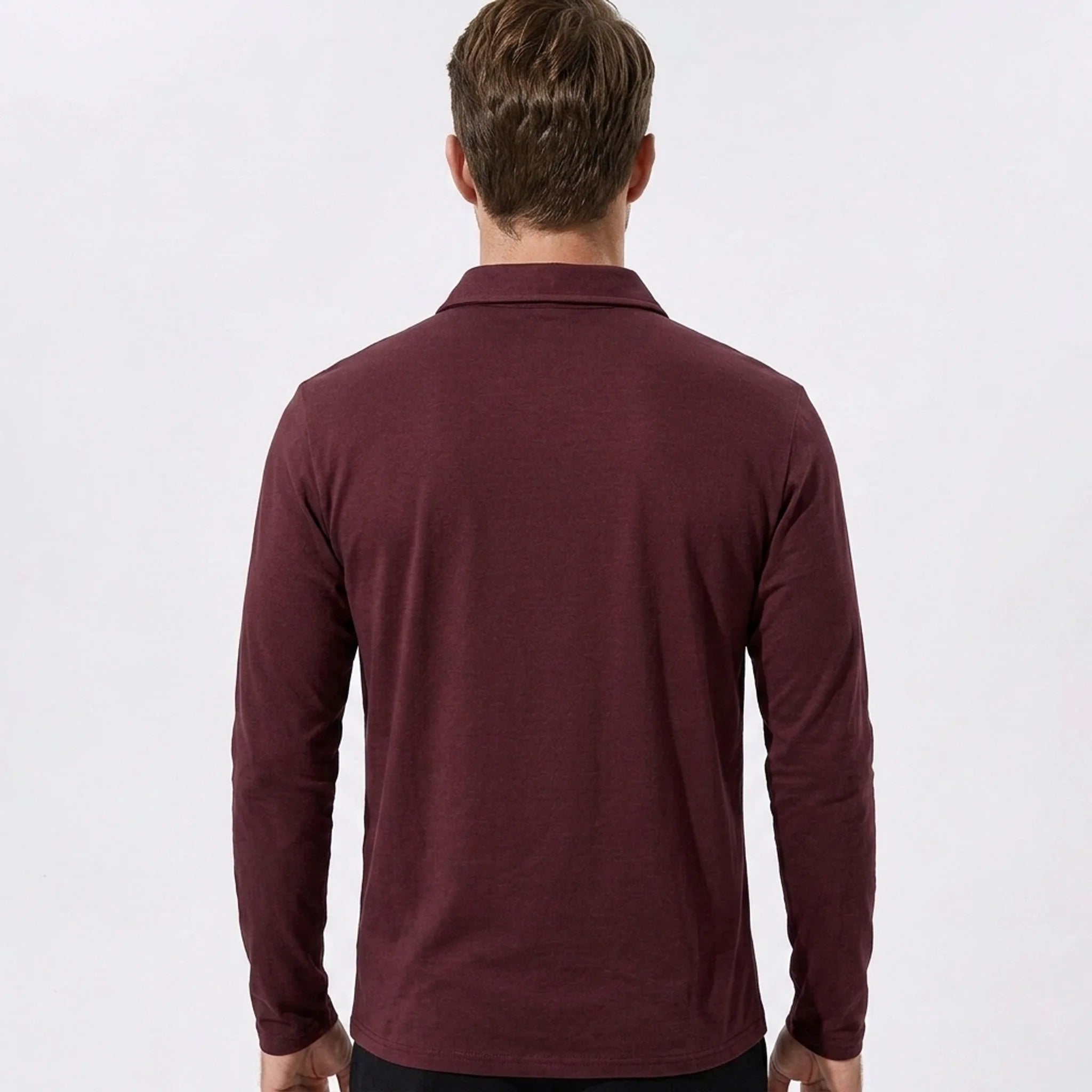 Man wearing gray solid long sleeve cotton polo shirt in outdoor lifestyle setting