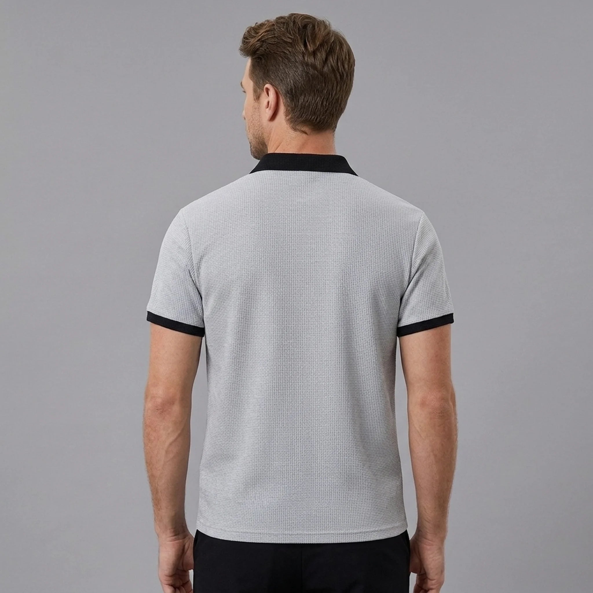 Man wearing grey color block waffle polo shirt in outdoor lifestyle setting