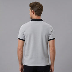 Man wearing grey color block waffle polo shirt in outdoor lifestyle setting