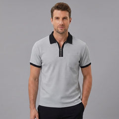 Side view of man in grey color block waffle polo shirt on plain background