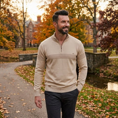 Man wearing MannerCo apricot half-zip cotton sweater slim fit in outdoor lifestyle setting