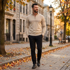 Man wearing MannerCo apricot half-zip sweater in outdoor autumn lifestyle setting