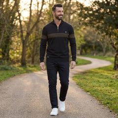 Man wearing MannerCo black half-zip sweater slim fit in outdoor lifestyle setting