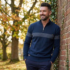 Man wearing MannerCo navy half-zip cotton sweater in outdoor autumn lifestyle setting