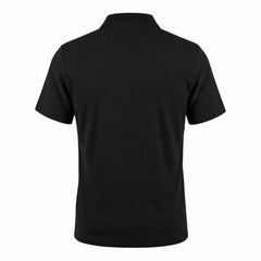 Man wearing MannerCo black jacquard knit polo shirt in outdoor lifestyle setting