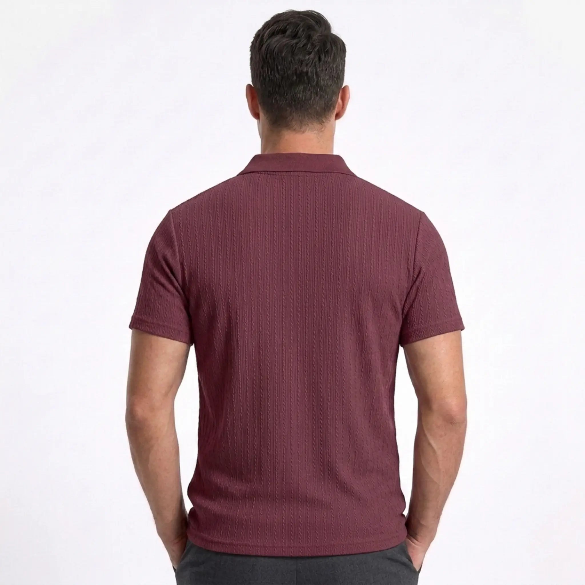 Man wearing MannerCo military green jacquard knit polo shirt in outdoor lifestyle setting