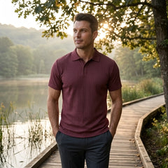 Man wearing MannerCo military green jacquard knit polo shirt in outdoor lifestyle setting