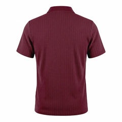 Man wearing MannerCo military green jacquard knit polo shirt in outdoor lifestyle setting