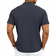 MannerCo navy blue jacquard knit polo shirt with classic collar and button placket, back view display